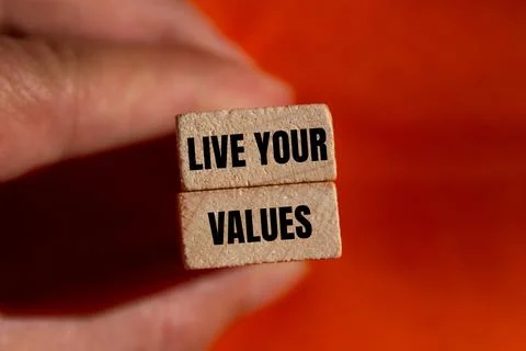 Live your values message written on wooden blocks with orange background. Con Stock-Fotos