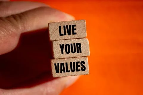 Live your values message written on wooden blocks with orange background. Con Stock-Fotos