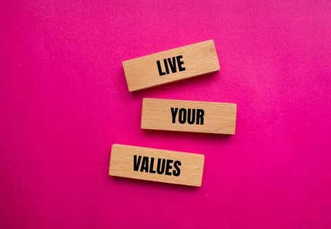 Live your values words written on wooden blocks with pink background 写真素材