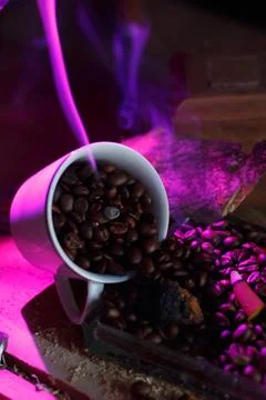 A lively and dynamic scene showcasing coffee beans beautifully spilling from  Stock Photos