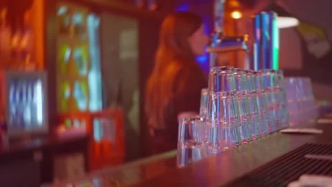 A lively and vibrant bar scene showcasing a stunning stack of colorful glasses Stock Footage 310334845