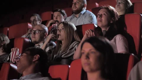 Lively audience chatting while watching movie Video stock 137298127