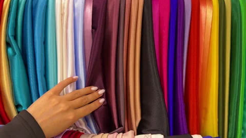 Lively Boutique Scene Featuring Customer Perusing Range Of Colorful Silk And Video stock 337939554