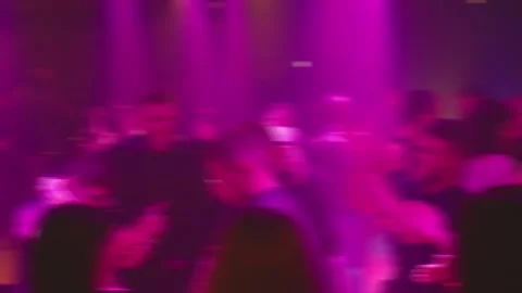 The lively dance floor is packed with a diverse crowd enjoying vibrant lights Video stock 316971514
