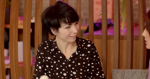 Lively interaction between two girlfriends meeting at cafe. Active conversation Stock Footage 265461042