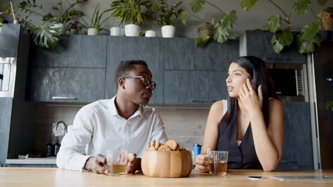 In a lively office setting, a black man and a woman enjoy a pleasant break Stock Footage 335752203