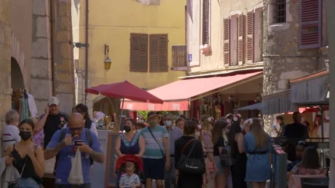 Lively tourist traffic after easing of pandemic restrictions in old town stre Stock Footage 157007486