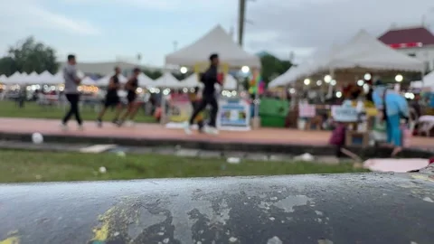 Lively twilight fairground featuring glowing vendor tents and an animated p.. Stock-Footage 325881227