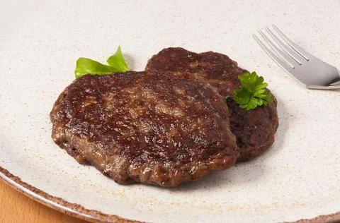 Liver cutlets on a light plate. close up Stock Photos