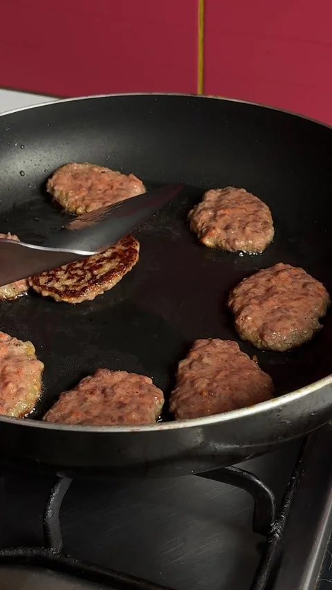 Liver cutlets wonderful close view person prepares meat on frying surface and Stock Footage 317699549