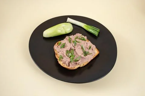 Liver paste pate, on a slice of toasted bread with sprinkled spring onion o.. Stock Photos