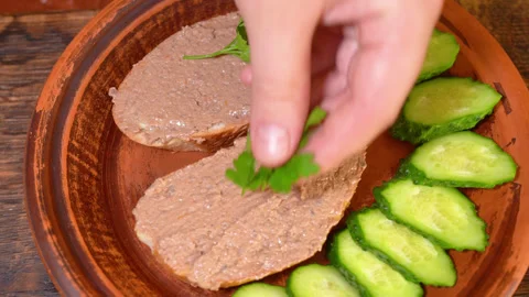 Liver pate on bread with cucumbers on a plate Stock Footage 254079882