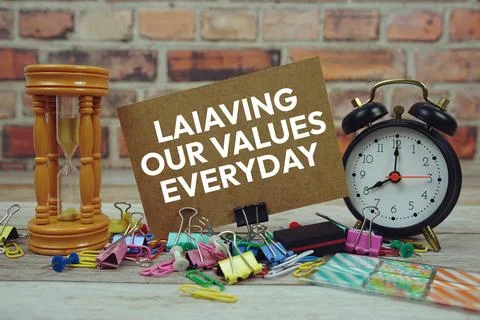 Living Our Values Everyday text on paper card with alarm clock and stationa.. Stock Photos