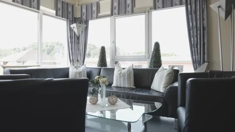 Living Room with Dark Leather Sofas and Large Windows, Home Interior, Wide Shot Vídeo Stock 341520750