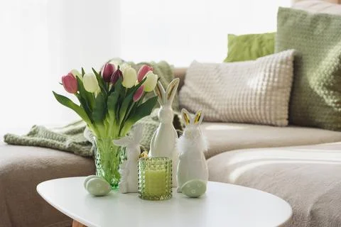 Living Room Decorated Easter Eggs with Bunny Figurines, Candles  and Tulips.. Stock Photos