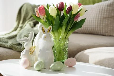 Living Room Decorated Easter Eggs with Bunny Figurines and Tulips. Cozy Spr.. Stock Photos