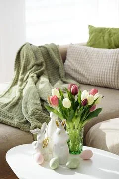 Living Room Decorated Easter Eggs with Bunny Figurines and Tulips. Cozy Spr.. Stock Photos