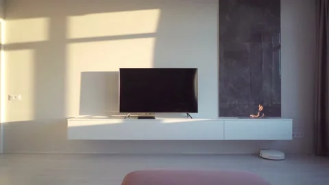 Living Room Interior in Light Tones with TV and Fireplace at Sunset Lights Stock Footage 202026367