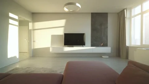 Living Room Interior in Light Tones with TV and Fireplace at Sunset Lights Stock Footage 202026378