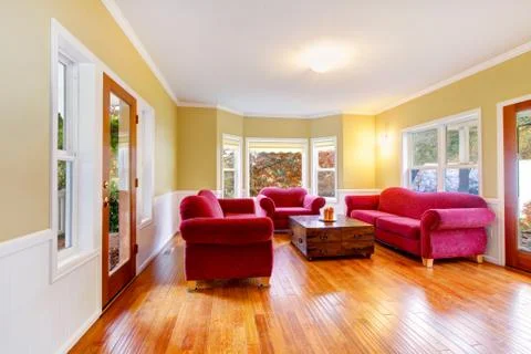 Living room interior with red sofas and old style coffee table with drawers a Stock Photos