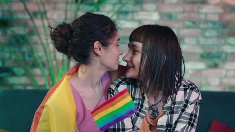In living room on the sofa closeup to the camera very lovely lesbian couple Stock Footage 201944184