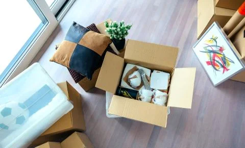Living room with stack of moving boxes Stock Photos