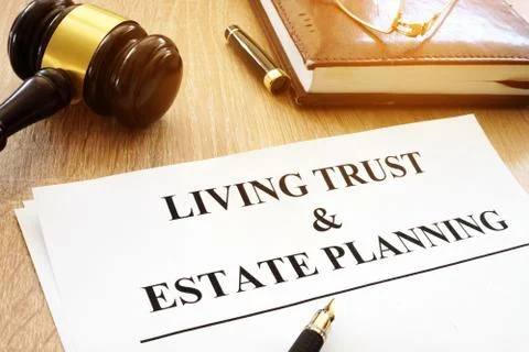 Living trust and estate planning form on a desk. Stock Photos
