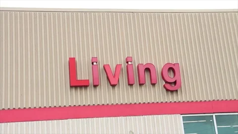 Living word writing caption text on beige wall building above red line in red Stock Footage 249759599