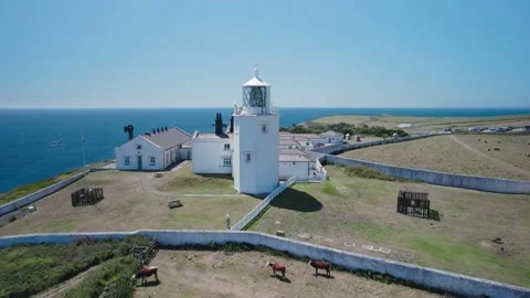 Lizard Lighthouse and Housel Bay Cliffs from a drone, Lizard, Helston, Cornwall Stock Footage 201200902