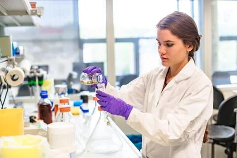 Llaboratory assistant pours liquid into test tube Stock Photos