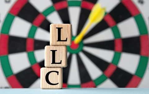 LLC - acronym on wooden cubes on dartboard background Stock Photos