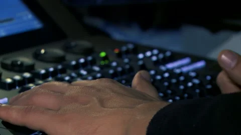 Llighting technician's hand while operating lights console Stock Footage 144430687