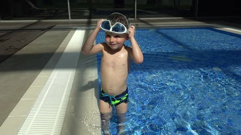 Llittle boy learns to dive in swimming glasses in the pool Stock Footage 104545915