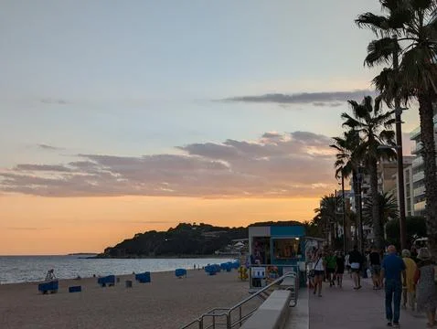 Lloret de Mar, Spain - September 09, 2024 Sunset over lined seaside promenade Fotos Stock