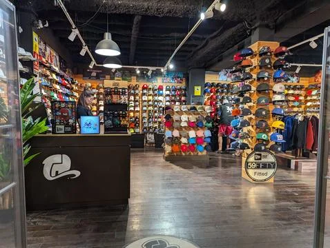 Lloret de Mar, Spain - September 09, 2024 Bright retail hat shop interior wit Stock Photos