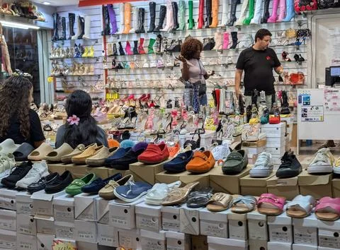 Lloret de Mar, Spain - September 09, 2024 Bright footwear shop interior with Stock Photos