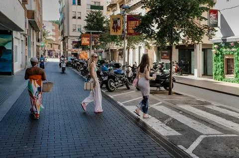 Lloret de Mar, Spain - September 09, 2024 Pedestrians crossing sunny Stock Photos