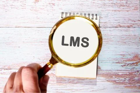 LMS - Learning Management System acronym. LMS found using a magnifying glass  Stock Photos