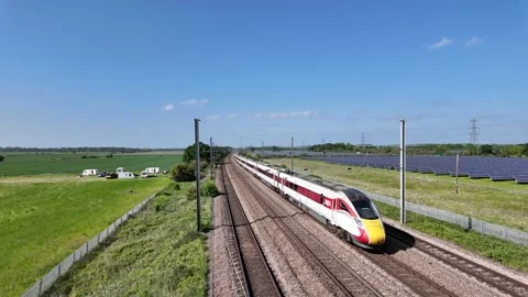 LNER Azuma Experss Train Passing the Solar Farm at Sandy Stock Footage 313687871