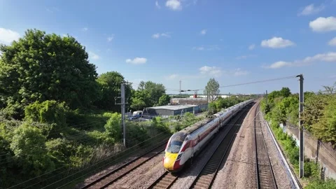 LNER Azuma Express Train Passing the Industrial District in Sandy Stock Footage 313695030