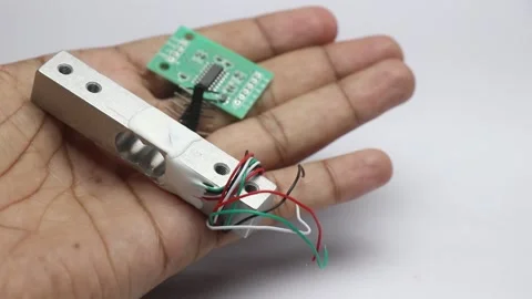 Load cell with its amplifier board without soldered pins held in the hand Video stock 315307038