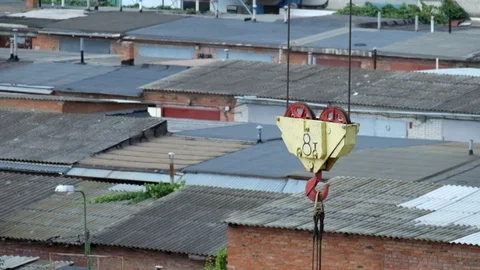 Load hook of the tower crane slowly sways from side to side Stock Footage 128817408
