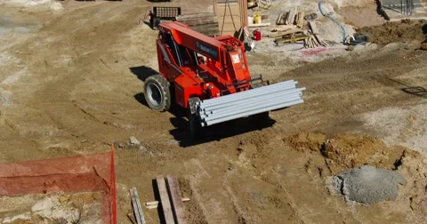 Load of Pipes Being Moved on Construction Site - 4k Stock Footage 56225421
