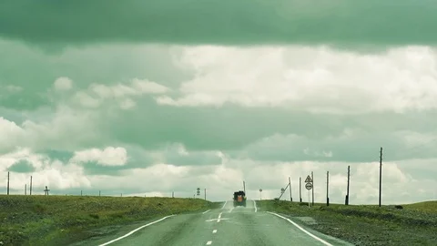 A loaded car is driving down the road in the mountains. Rain and overhanging Video stock 93200697