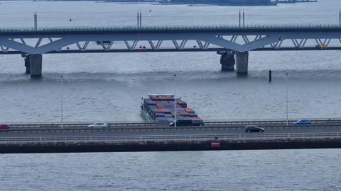 Loaded Cargo Ship Sailing On Hollands Diep With View Of Road And Railway Stock Footage 249270564
