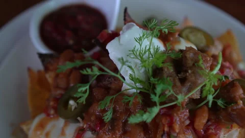 Loaded cheese and chilli nacho  taco topping Mexican famous food 4k Stock Footage 309847939