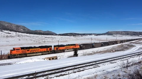 Loaded coal train L-R across sceneand exits under sunny blue skies, 5 clips in 1 Stock Footage 105191203