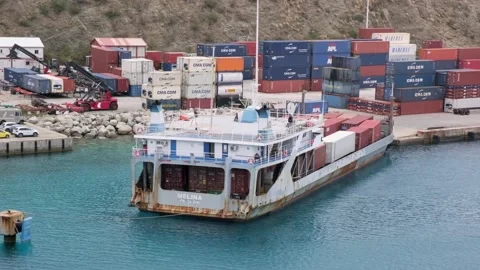 Loaded container barge is moors at berth of cargo terminal in Sint Maarten port Stock Footage 233398353