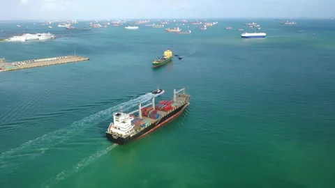 Loaded container cargo vessel traveling being assisted by tugboat docking on Video stock 336445902
