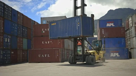 Loaded container handler transporting and packing a shipping container UHD25p Stock Footage 246487252